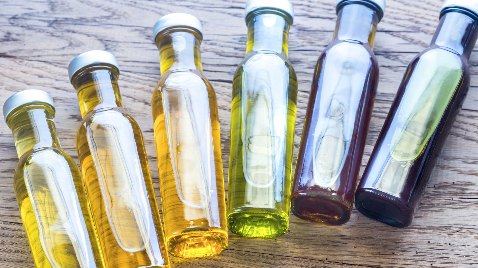 An overhead shot of bottles of different liquids that showcases the difference between horticultural oil vs neem oil